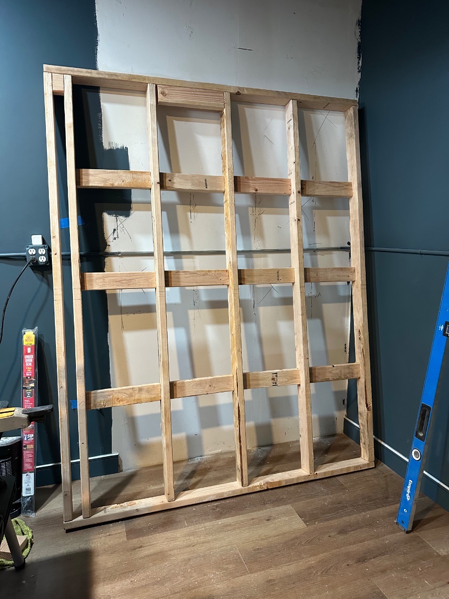 Panagraph Studios build — an acoustic wall frame built on the floor before insulating