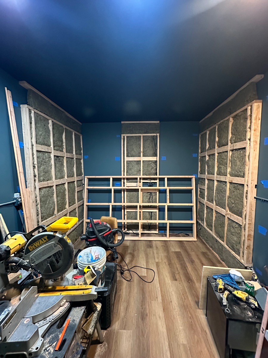 Panagraph Studios build — the front acoustic wall framed low and wide around the cable runs
