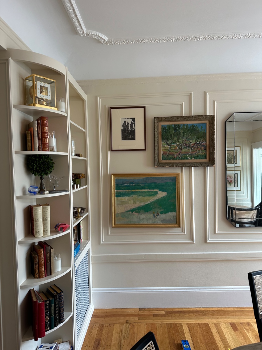 Pacific Heights — the left panel hung: a small etching, an olive-wood framed landscape and a gilt-framed coastal oil, with the mirror at the edge of the frame