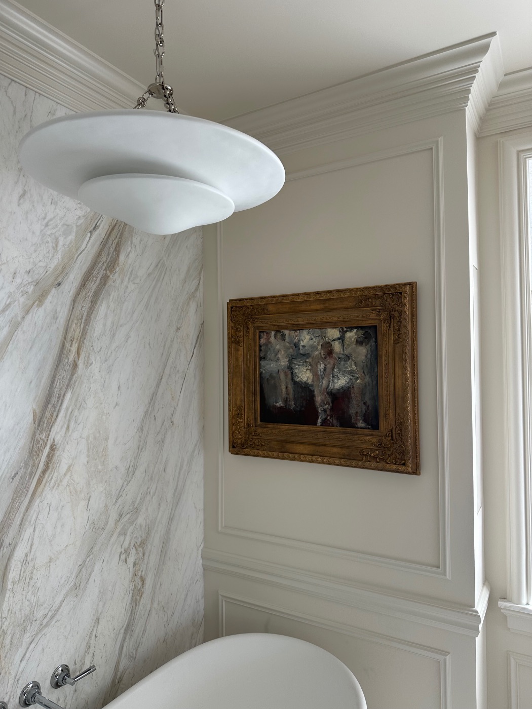 An impressionist work installed in a marble bath