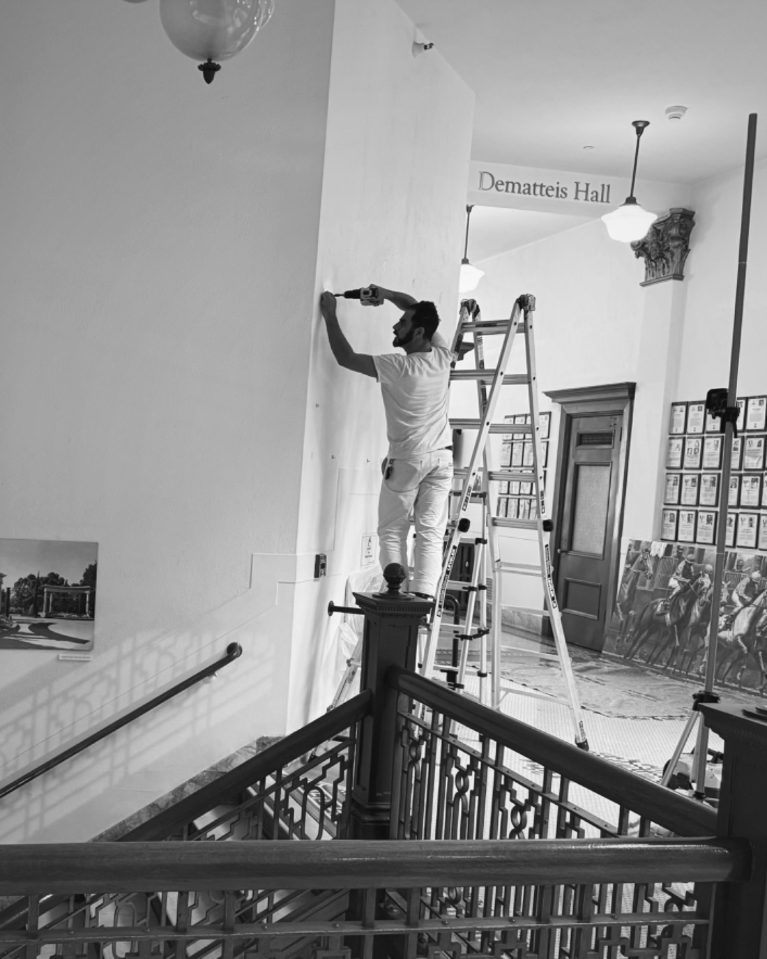 Kayhan Golkar of Aero Luxe setting fixings from a ladder during an installation