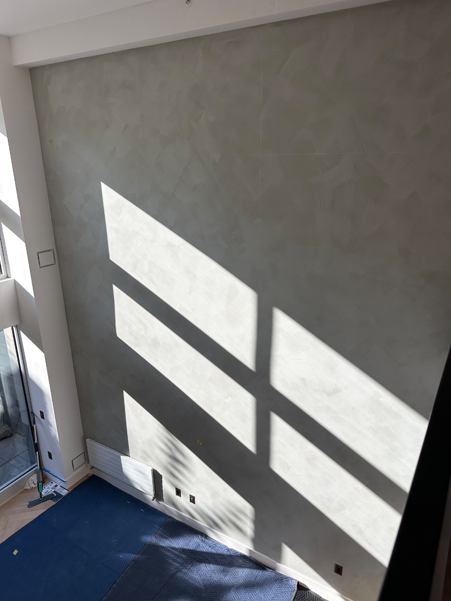 Russian Hill gallery wall — afternoon light crossing the polished plaster wall