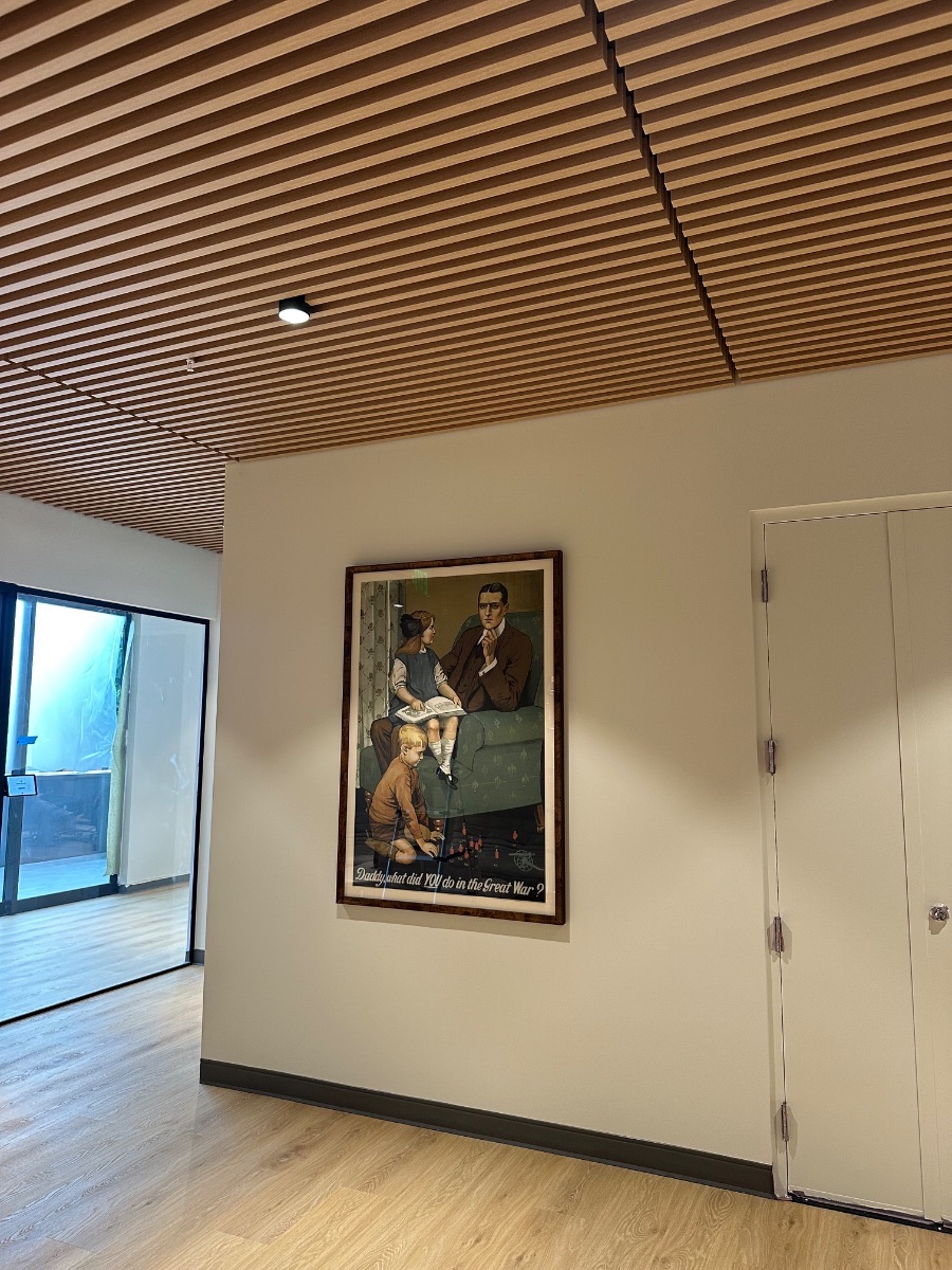 Fine art installation by Aero Luxe &mdash; A period poster installed under a slatted timber ceiling, Palo Alto, California