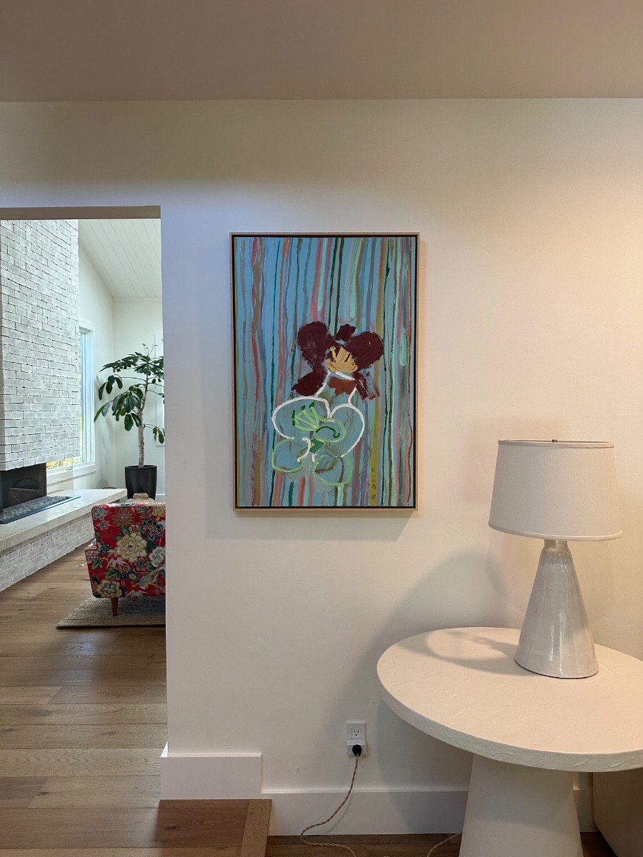 Fine art installation by Aero Luxe &mdash; A striped canvas hung beside a console and lamp, Carmel, California