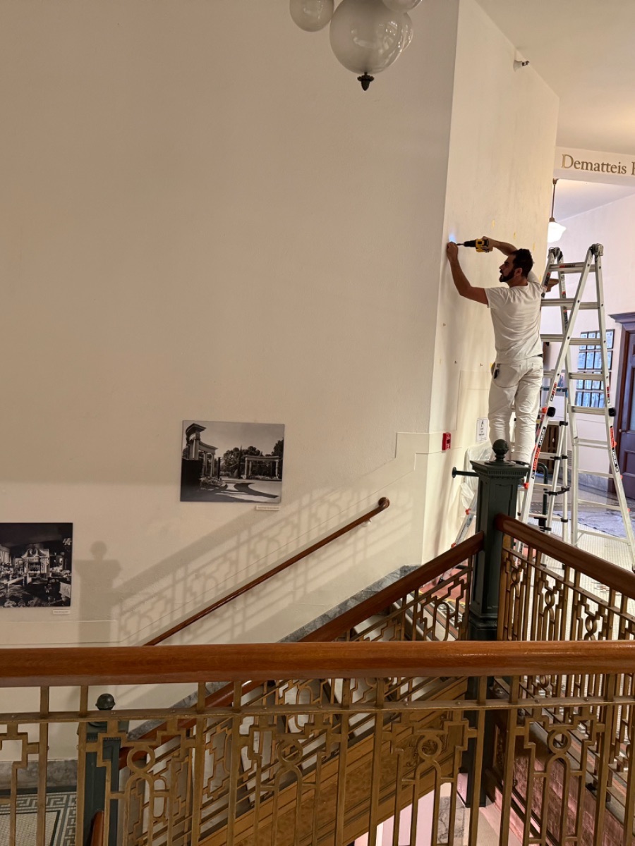 Fine art installation by Aero Luxe &mdash; Marking out a museum wall above the stair before installing a large historical work, San Mateo, California
