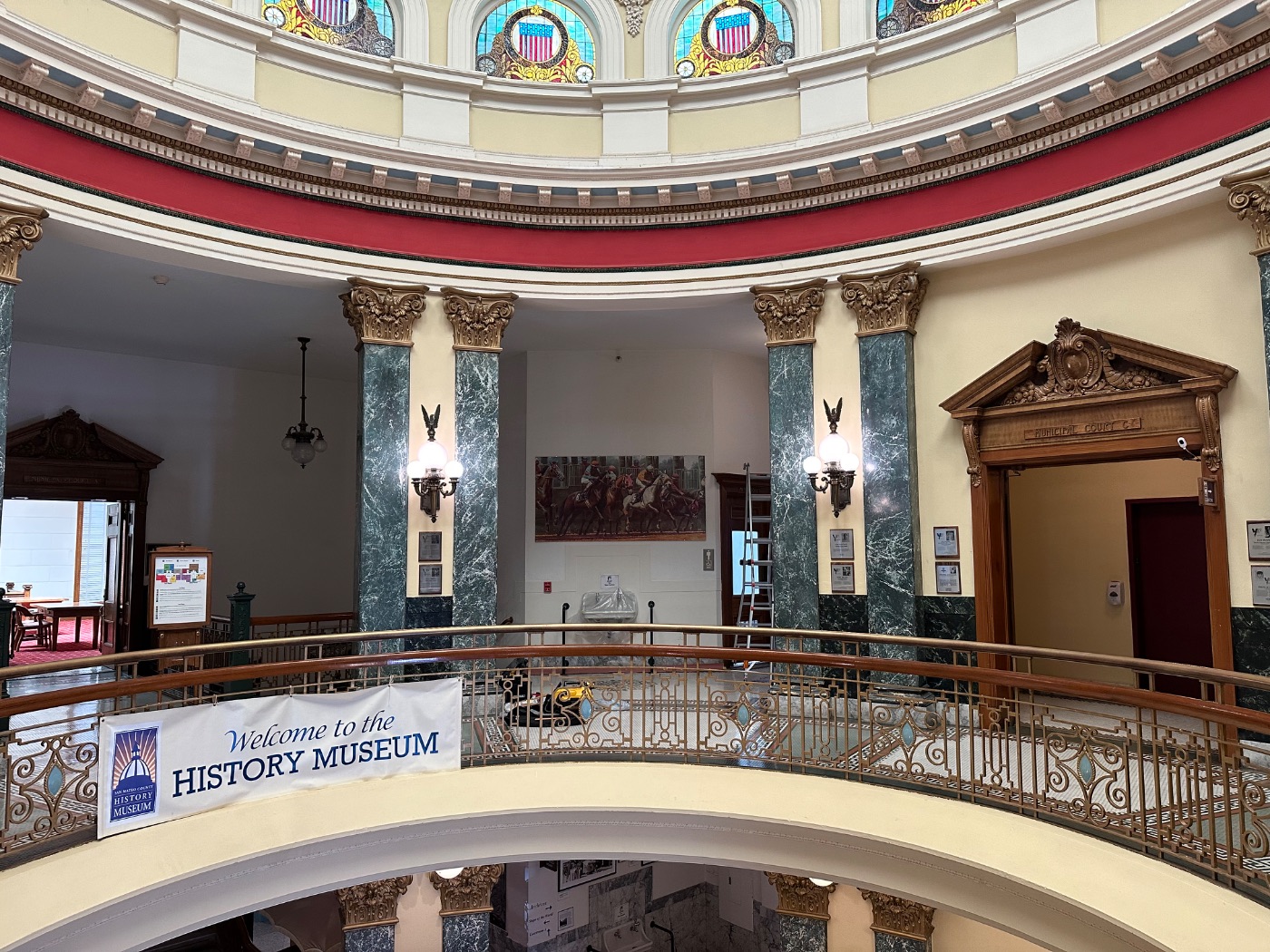The Bay Meadows racing painting installed on the rotunda wall of the San Mateo County History Museum, beneath the stained-glass dome