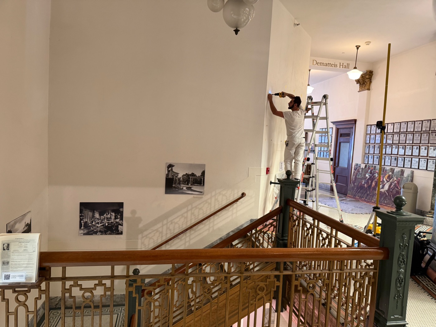 Aero Luxe setting the bracket fixings for the Bay Meadows painting at the San Mateo County History Museum