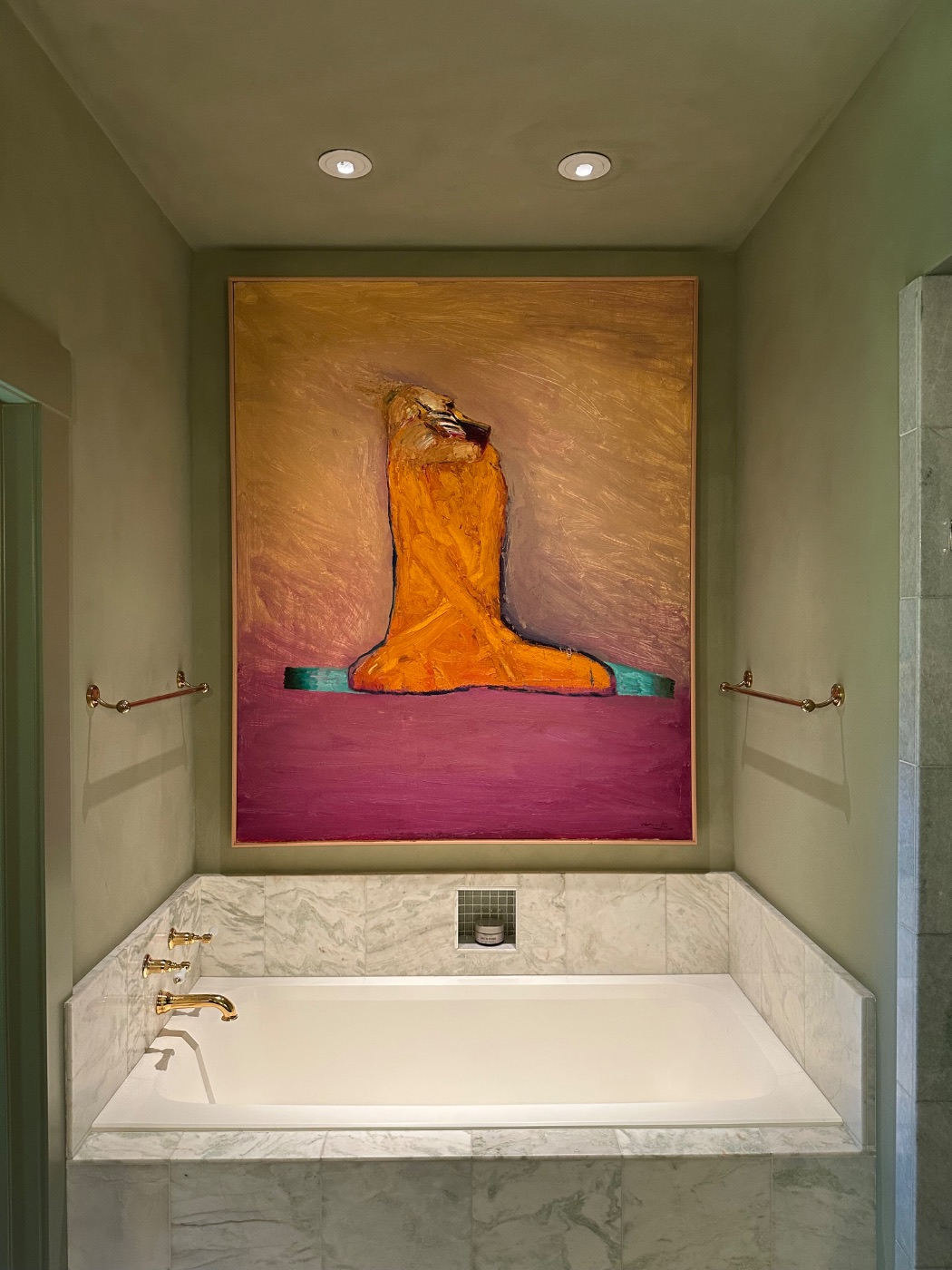 A large figurative painting hung above the tub on lime plaster, Montecito, California